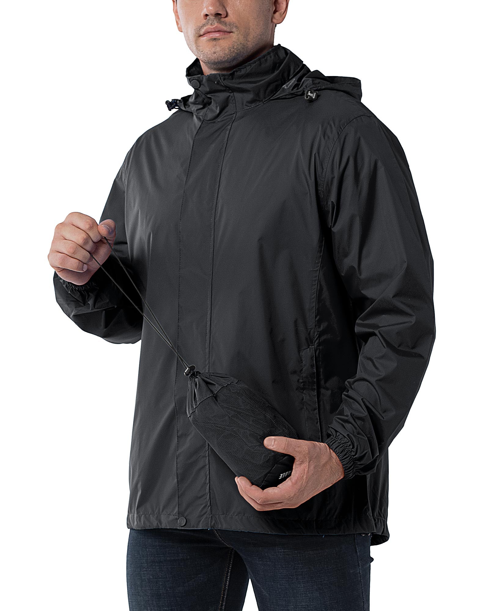 Man wearing a 33,000ft black packable rain jacket with the stuff pouch in hand