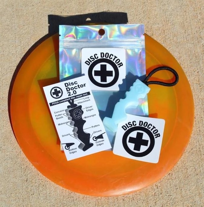 Disc Doctor 2.0 repair tool with sample discs and packaging