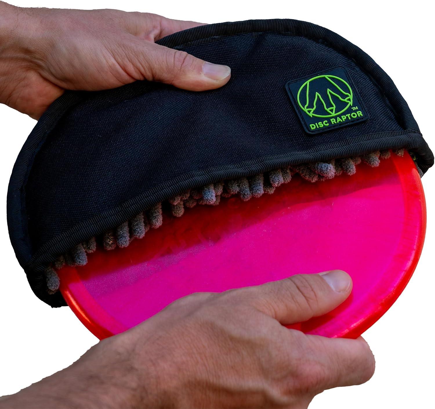 Disc Raptor disc golf cleaning tool with microfiber interior wiping a disc