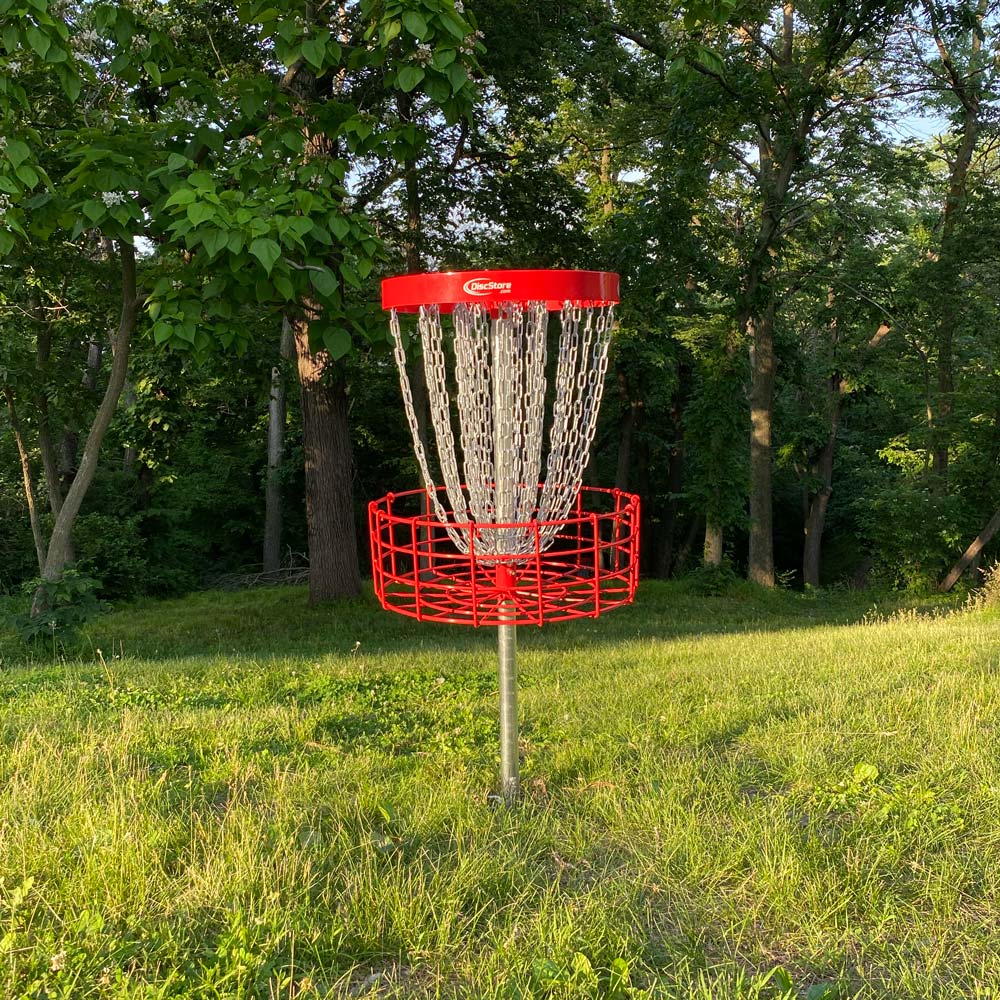 GrowTheSport Champion permanent disc golf basket installed in the ground